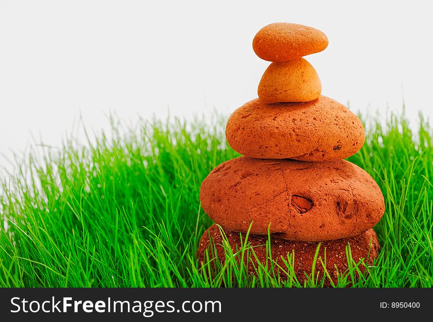 Red Pyramid of cobble-stones in the green grass