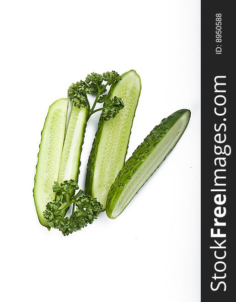 Cutted cucumbers and parsley, healthy food on white