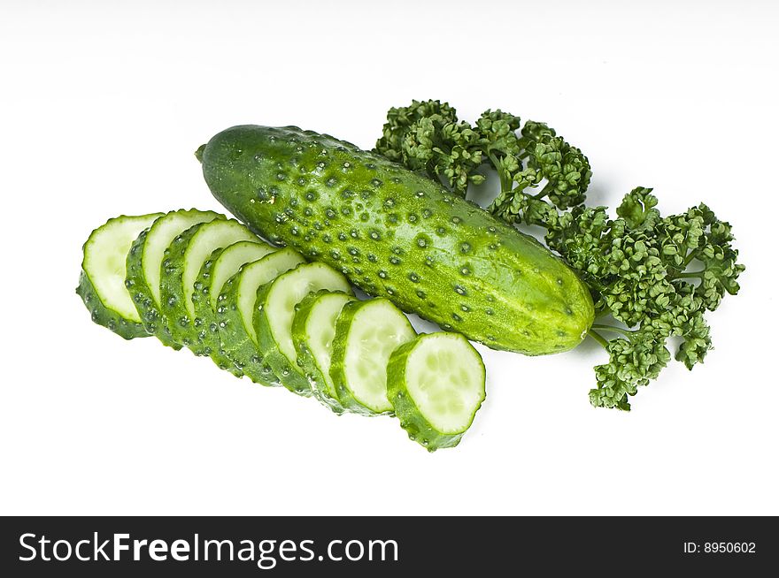 Cutted cucumbers and parsley, healthy food isolated on white