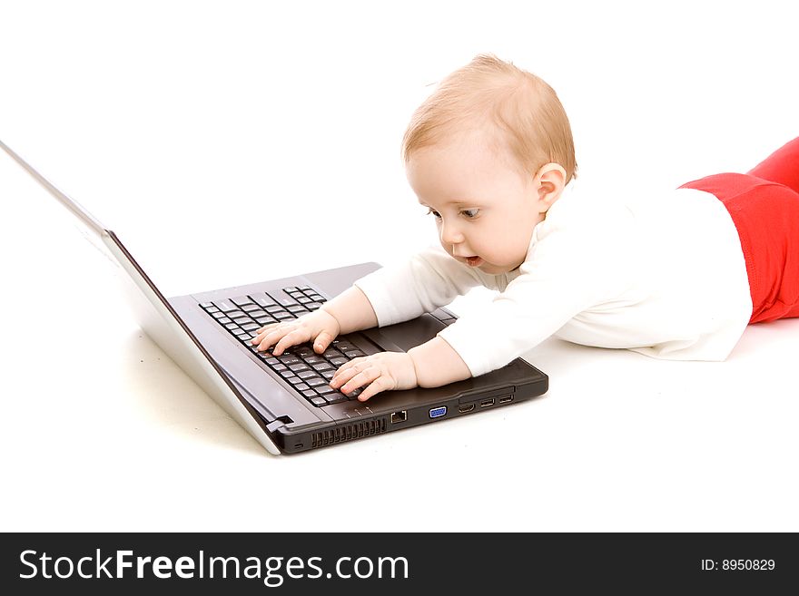 Baby with laptop on white