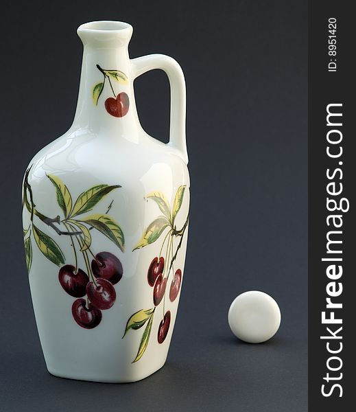 A white wine flagon with painting on dark background