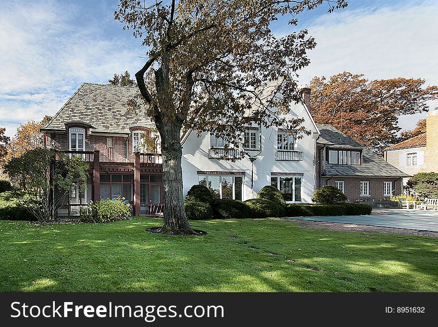 Rear view of luxury brick home during autumn. Rear view of luxury brick home during autumn