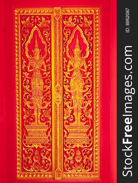 Traditional Thai art church door of Wat Klang Wiang, Chiang Rai province, Thailand