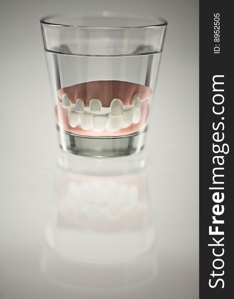 False teeth in a glass