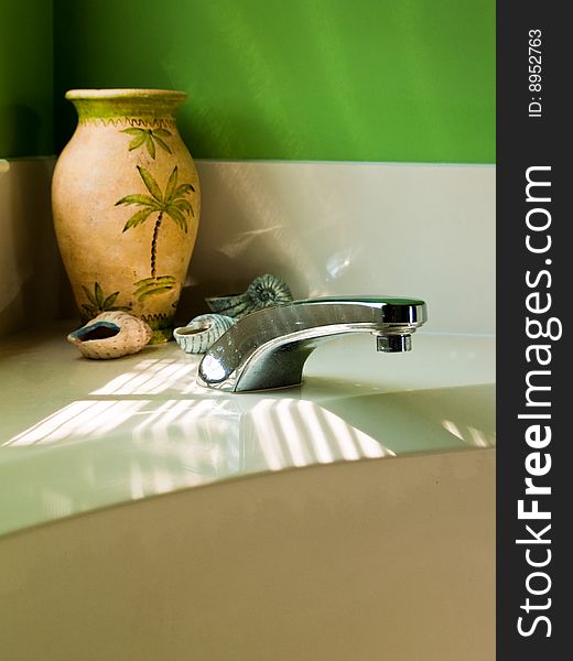 Crafted Seashells and Vase on a white ledge in the corner of a modern, luxurious Bathroom. Crafted Seashells and Vase on a white ledge in the corner of a modern, luxurious Bathroom.