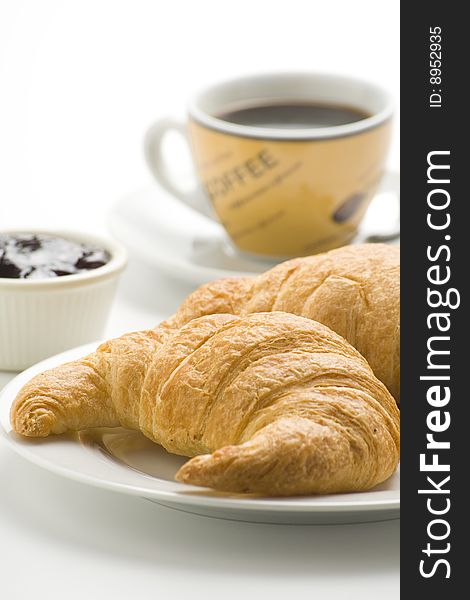 Delicious continental breakfast of coffee and croissants isolated