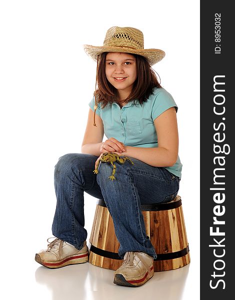 A preteen farmer-girl proudly displaying a large, spotted green frog on her knee.  Isolated on white. A preteen farmer-girl proudly displaying a large, spotted green frog on her knee.  Isolated on white.