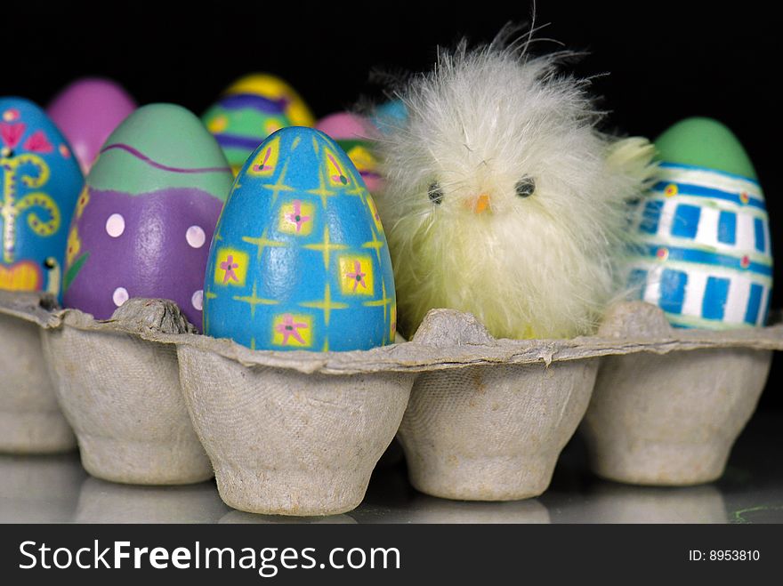 Fuzzy chick with Easter eggs in carton. Fuzzy chick with Easter eggs in carton.