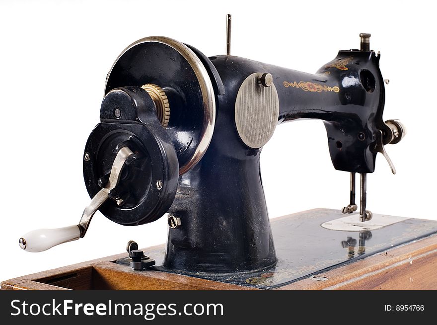 Old black sewing machine on white background