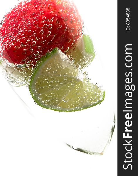 Strawberry and Limes in a cool refreshing drink on an isolated background