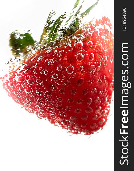 Strawberry in refreshing drink on a white background. Strawberry in refreshing drink on a white background