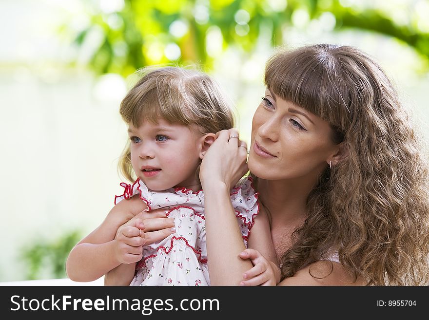 Portrait of happy mother with daughter  having good time in summer environment. Portrait of happy mother with daughter  having good time in summer environment