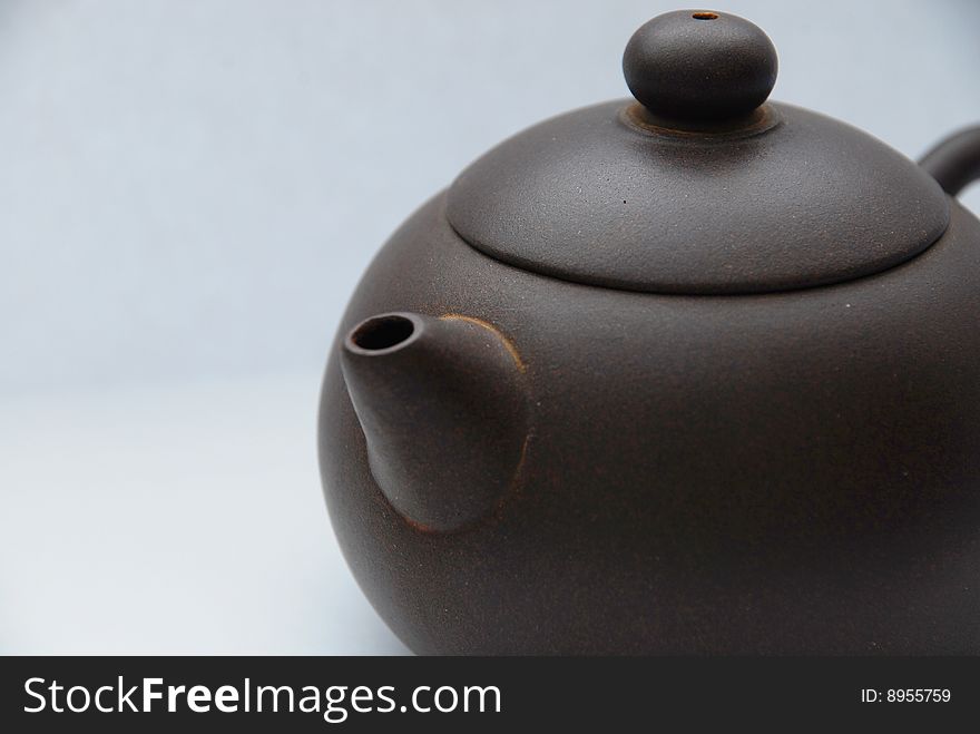 Chinese ceramic teapot with ornament on white background