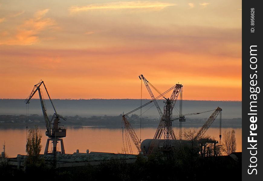 A shipyard on a beautiful sunset.