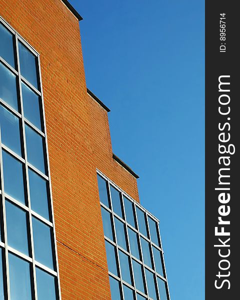 Brick and glass architecture against blue sky. Brick and glass architecture against blue sky