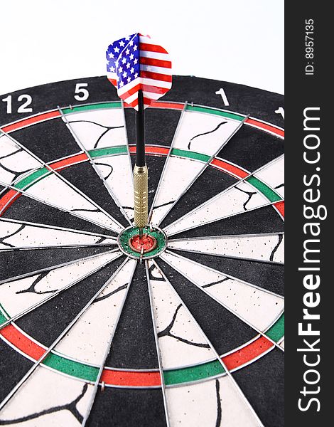 Darts target with a dart stuck in the center,numerous target
and practice.