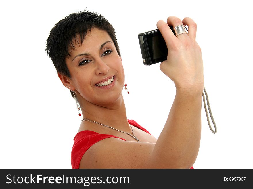 Half body view of attractive brunette photographing herself with small camera. Isolated on white background. Half body view of attractive brunette photographing herself with small camera. Isolated on white background.