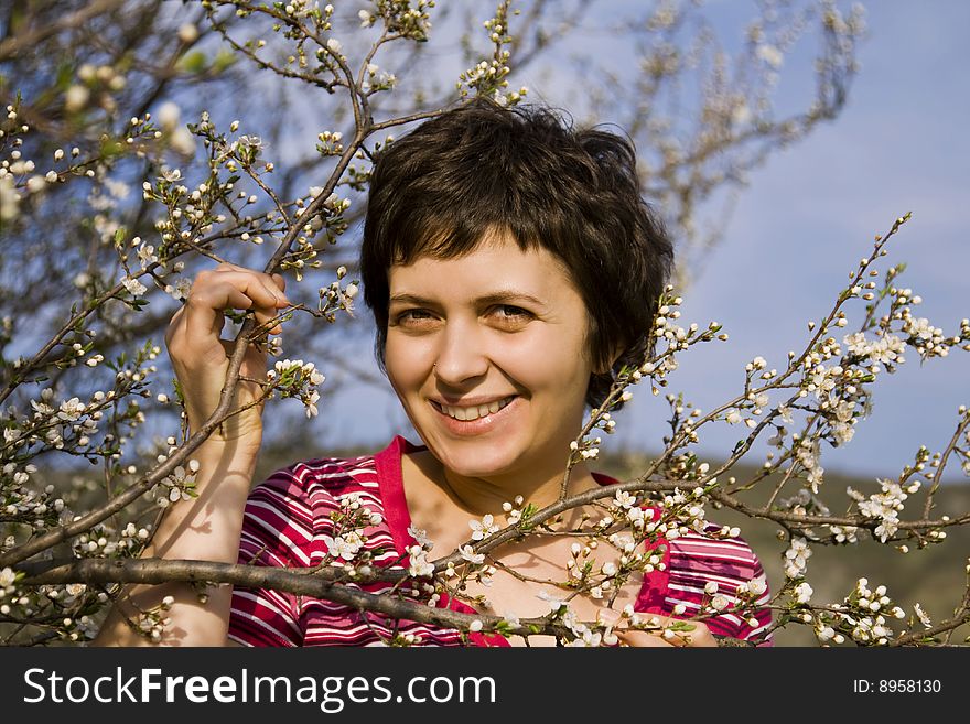 Young Woman Amongst Spring Blossom