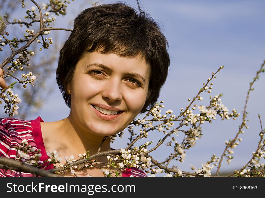 Beautiful woman amongst spring blossom