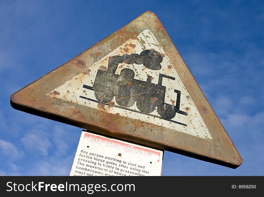 An old road sign with steam locomotive image. An old road sign with steam locomotive image