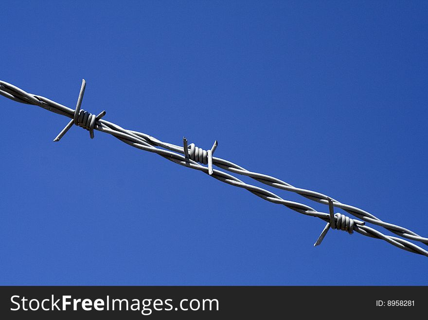 Barbed wire with a blue sky background