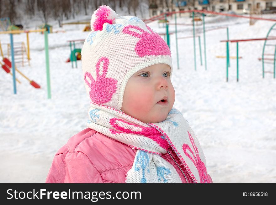 Little Girl On Winter Playground.