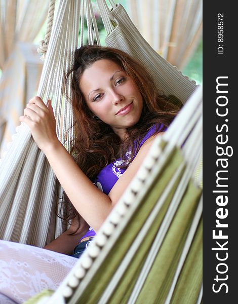 Beautyful long-haired girl relaxing in hammock