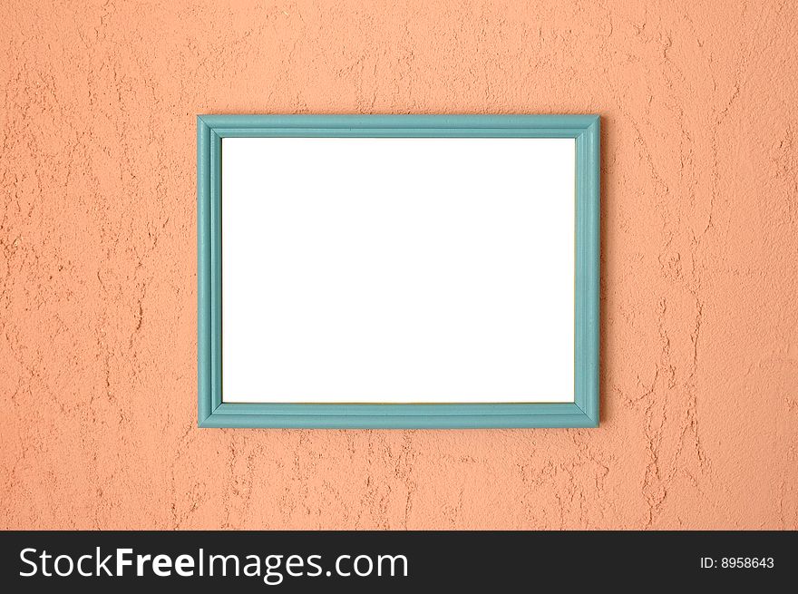 Photo frame on brightly coloured pink stucco wall.