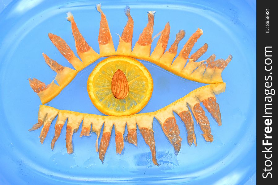 Eye from fruit on a blue background.