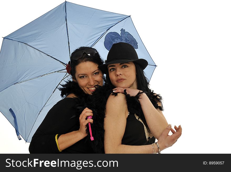 Half body view of two young womans under the same blue umbrella, in a fashion pose. Isolated on white background. Half body view of two young womans under the same blue umbrella, in a fashion pose. Isolated on white background.