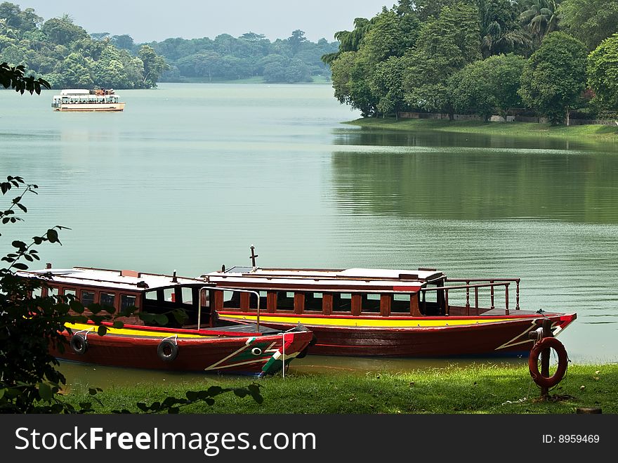 Lakeside with boats parking in green background. Lakeside with boats parking in green background