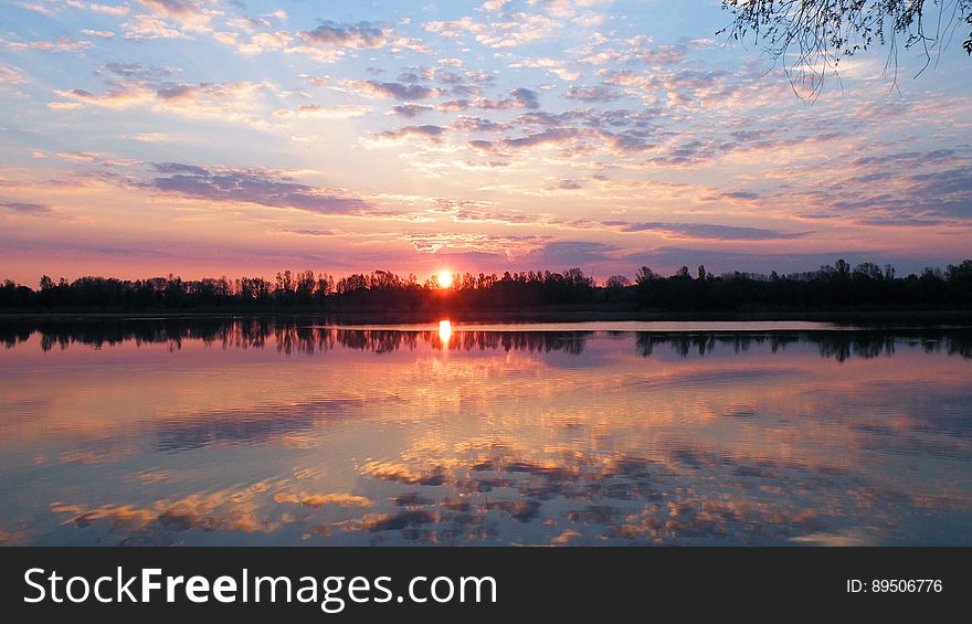 Sun Set Reflecting In Calm Lake