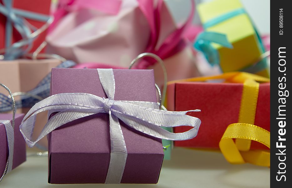 A colorful background of wrapped presents with ribbons.