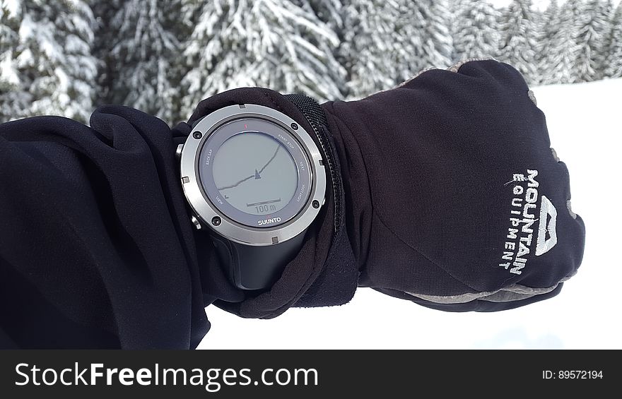 A man in the winter forest wearing a sports and activity tracking watch with GPS. A man in the winter forest wearing a sports and activity tracking watch with GPS.
