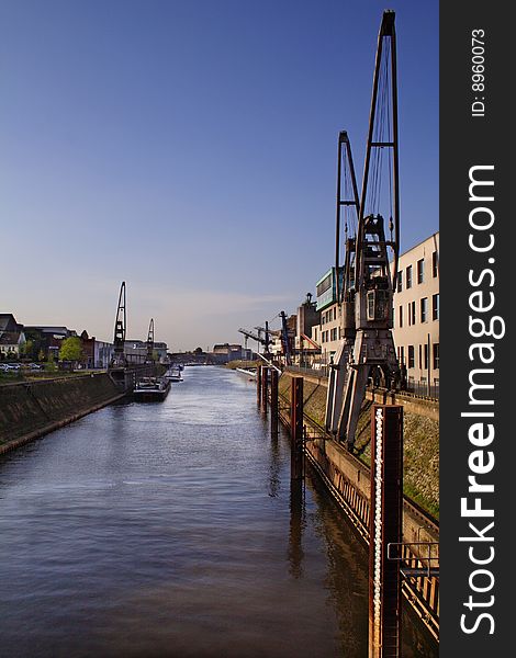 Typical industrial harbor scene in front of a blue sky. Typical industrial harbor scene in front of a blue sky.