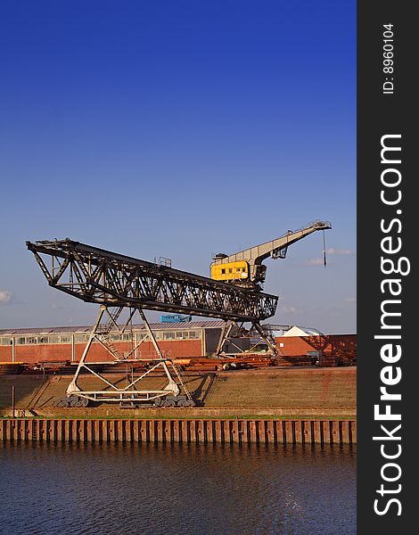 Typical industrial harbor scene in front of a blue sky. Typical industrial harbor scene in front of a blue sky.