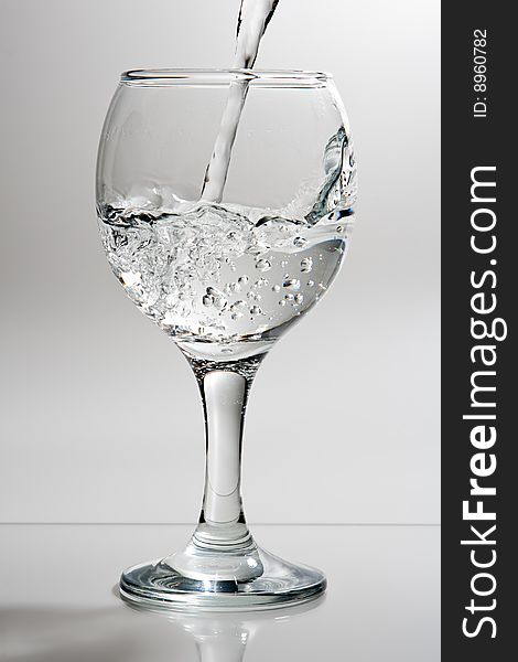 Wine glass with poured water. Wine glass with poured water