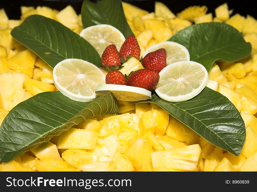 Fruit Salad display with strawberries and fresh leaves