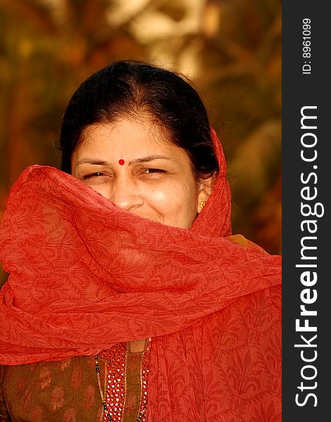 A portrait of a traditional Indian woman hiding her face. A portrait of a traditional Indian woman hiding her face.