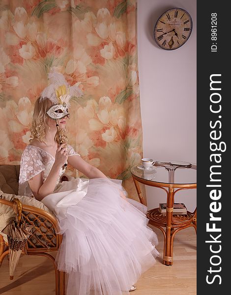 Beautiful model wearing a wedding dress and Venetian mask, studio. Beautiful model wearing a wedding dress and Venetian mask, studio