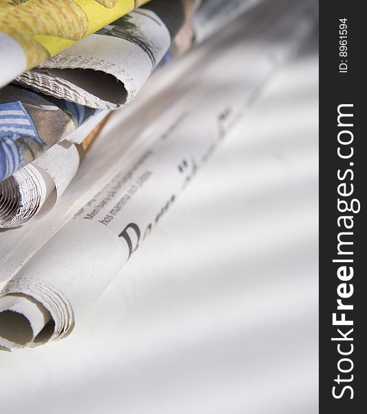 Pile of newspapers on white table