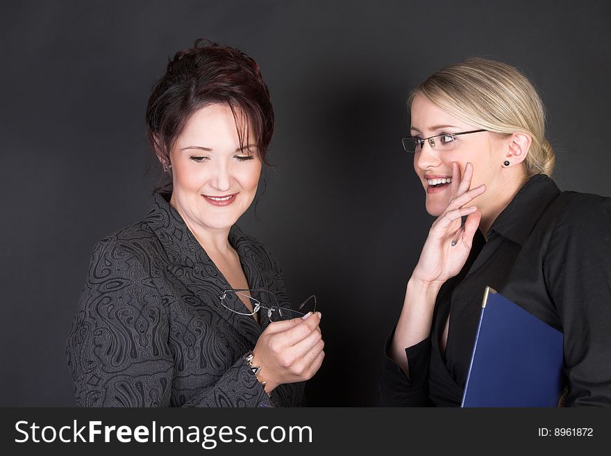 Composed Businesswomen holding a blue file against a black background. Composed Businesswomen holding a blue file against a black background