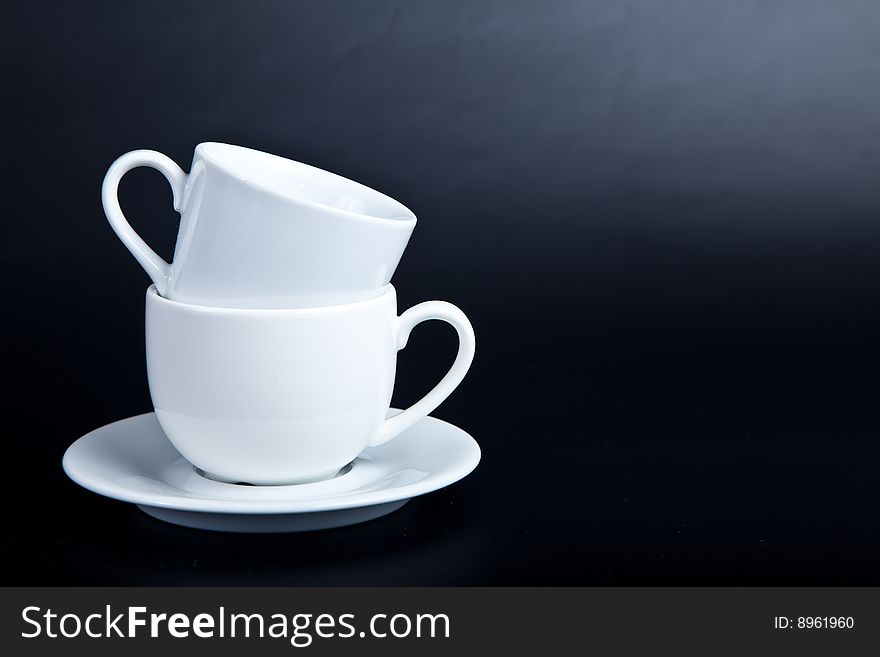 Two Cups Of White On A Black