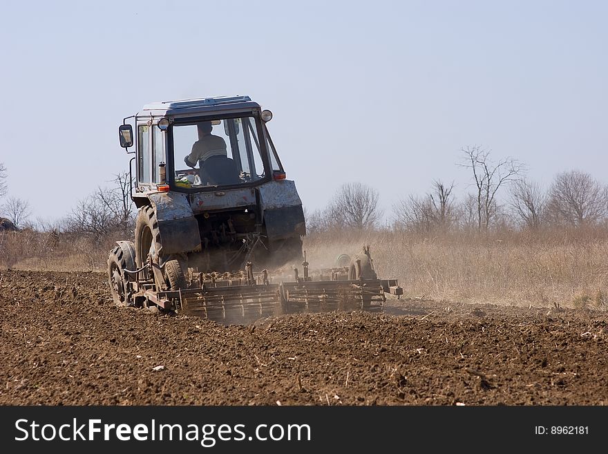 A tractor sowing seed in the field