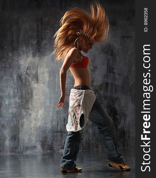 Modern style dancer posing behind studio background. Modern style dancer posing behind studio background