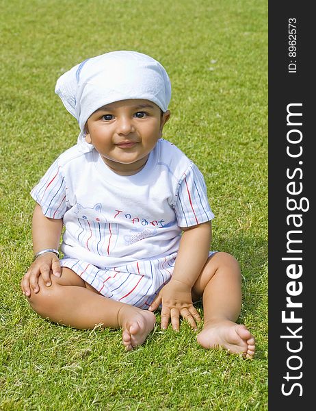 Happy baby playing on grass. Happy baby playing on grass