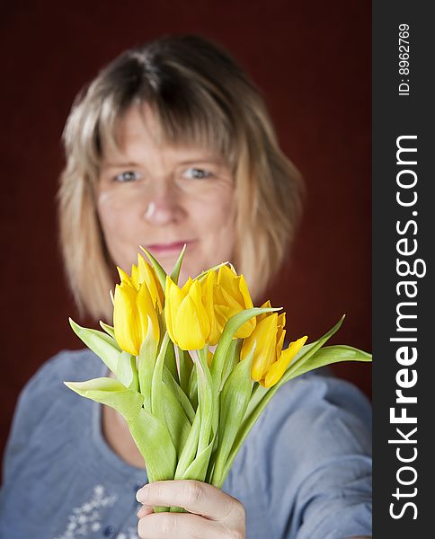 Pretty woman with a bunch of yellow tulips. Pretty woman with a bunch of yellow tulips