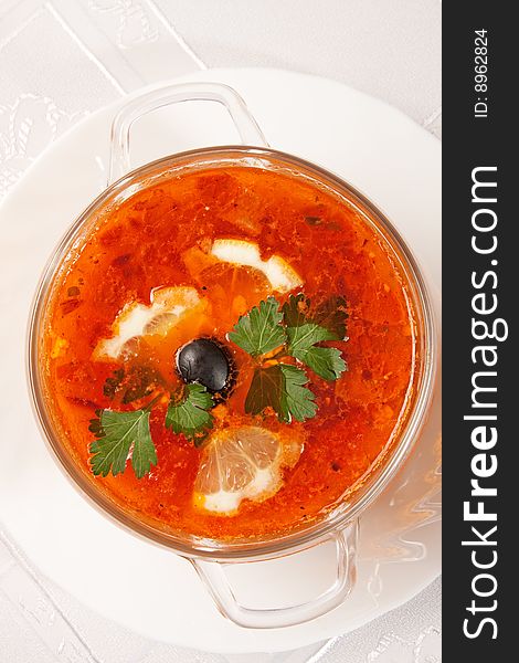 Tasty red soup with lemon over white