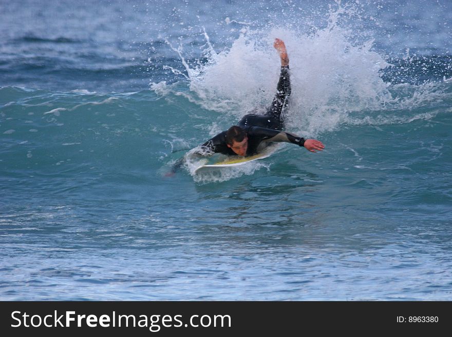 Surfer trying to catch a wave