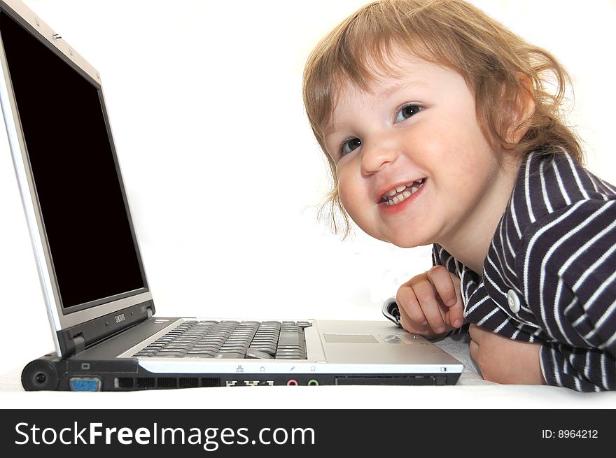 Baby girl working on laptop isolated white. Baby girl working on laptop isolated white